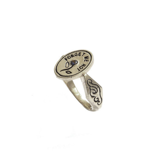 Hunt Of Hounds Forget Me Not Ring. Text surrounding a flower set with sapphire.