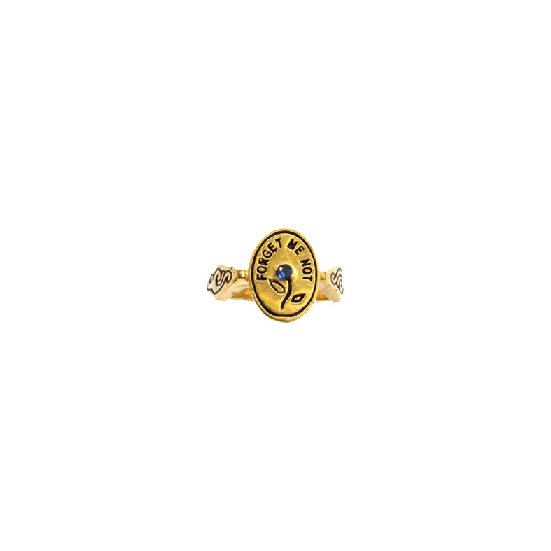 Hunt Of Hounds Forget Me Not Ring. Text surrounding a flower set with sapphire.
