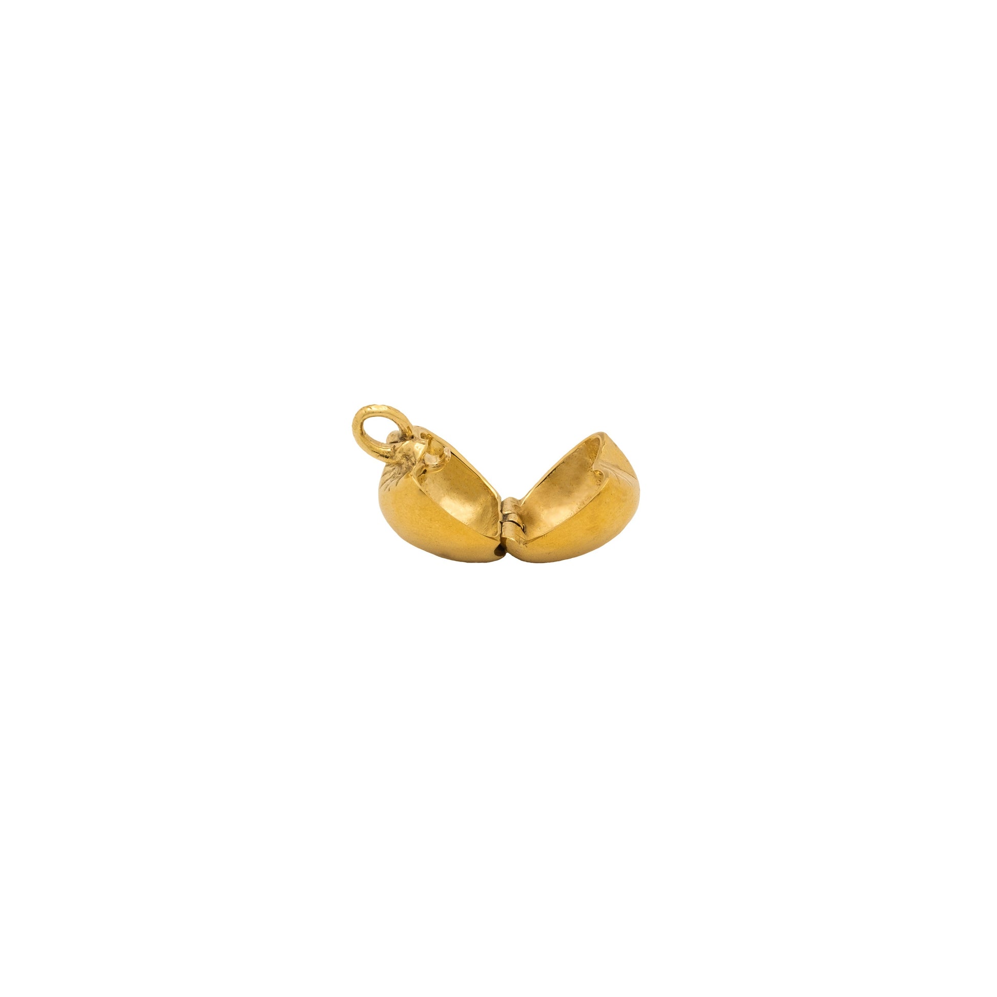 Gold pendant shaped like an apple on a white background