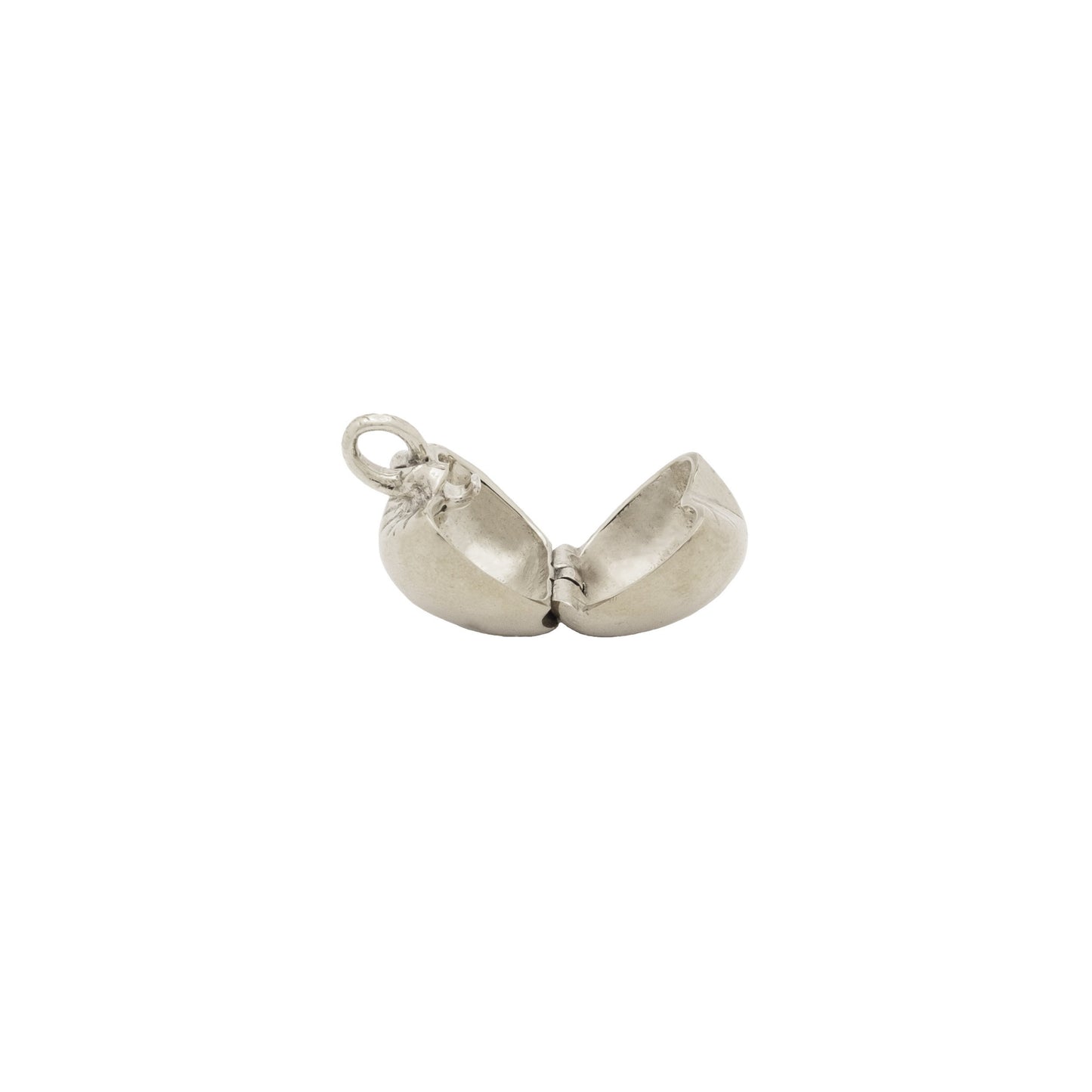 Silver charm shaped like an apple on a white background