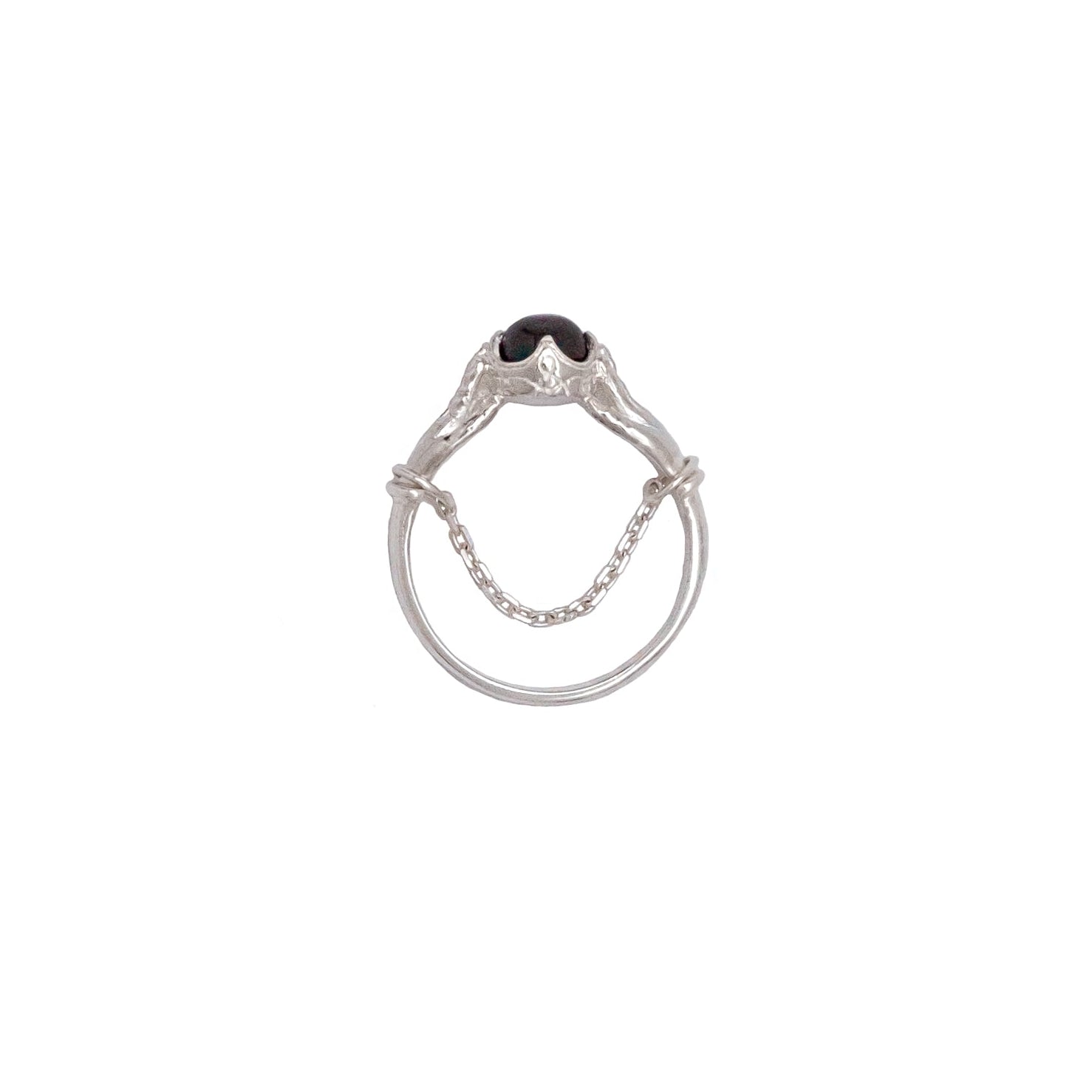 Silver ring with a red gemstone on a white background