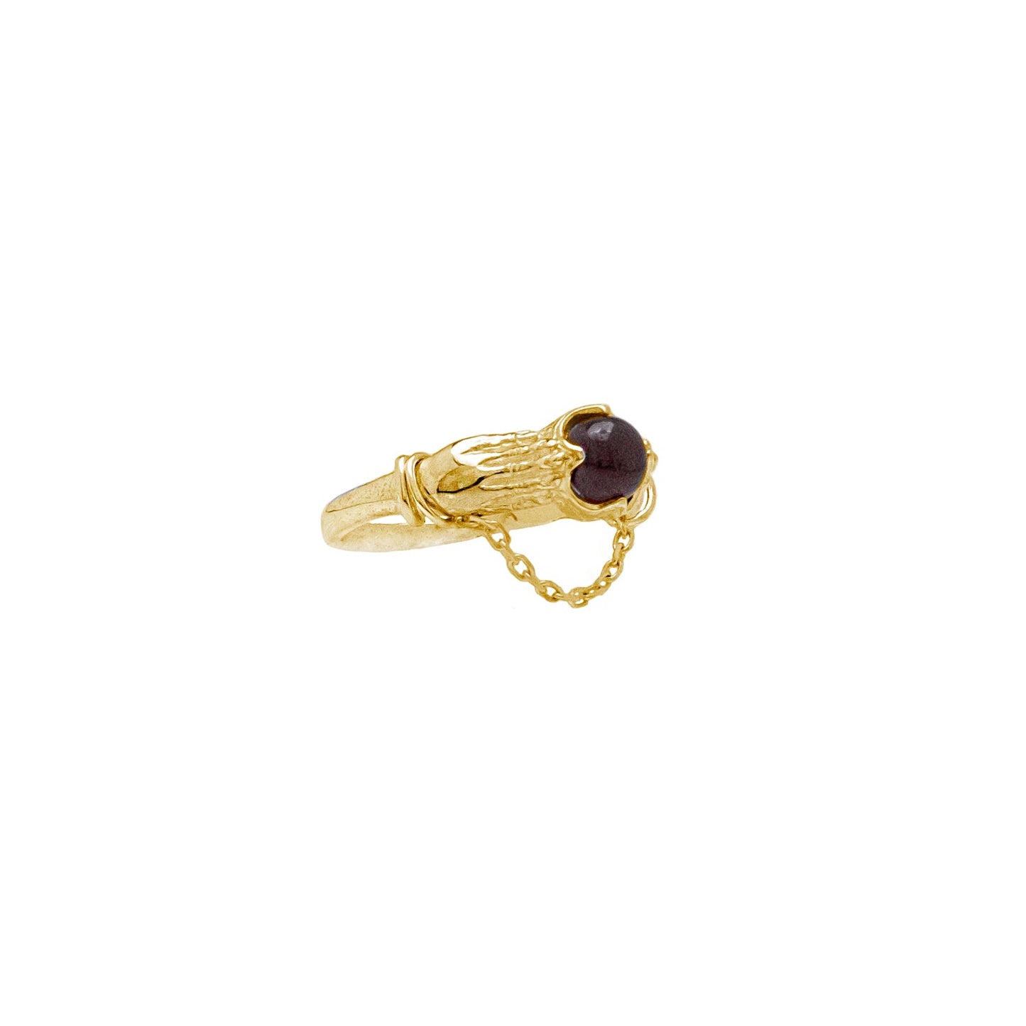Gold ring with a dark red gemstone on a white background