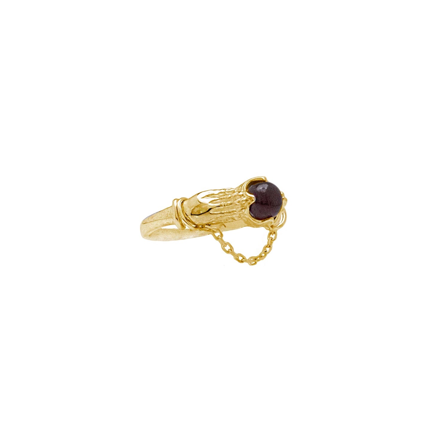 Gold ring with a dark red gemstone on a white background