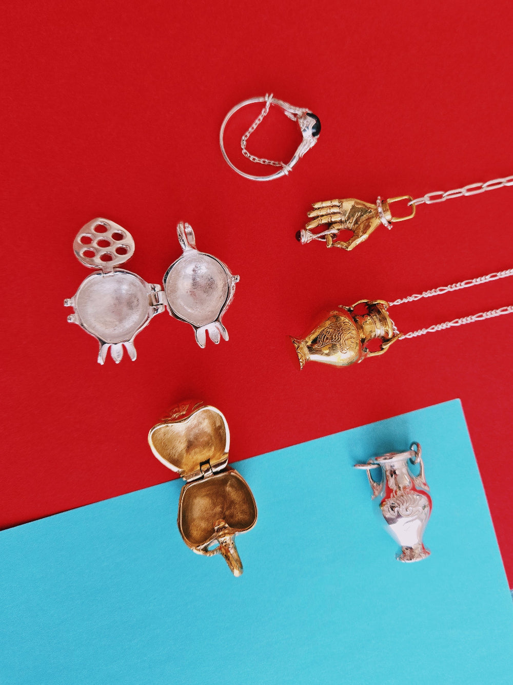 Jewelry items including pendants and a ring on a red and blue background