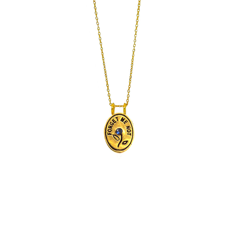 Hunt Of Hounds Forget Me Not Necklace. Text surrounding a flower set with sapphire.