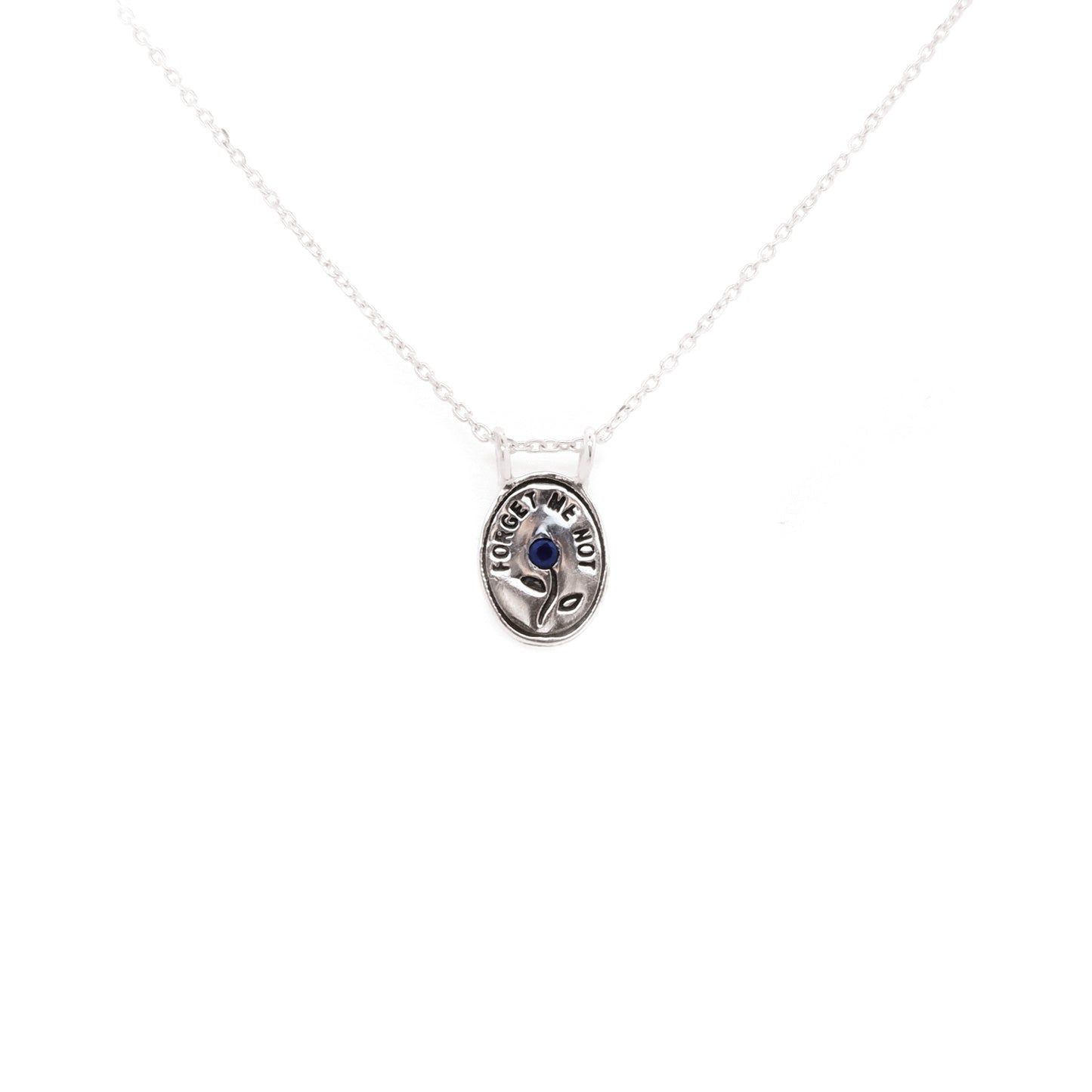 Hunt Of Hounds Forget Me Not Necklace. Text surrounding a flower set with sapphire. 